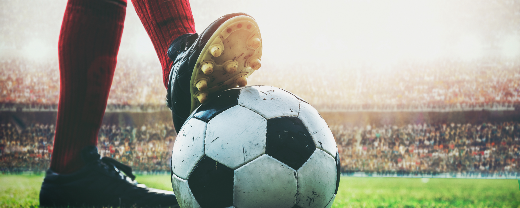 Soccer players foot on soccer ball