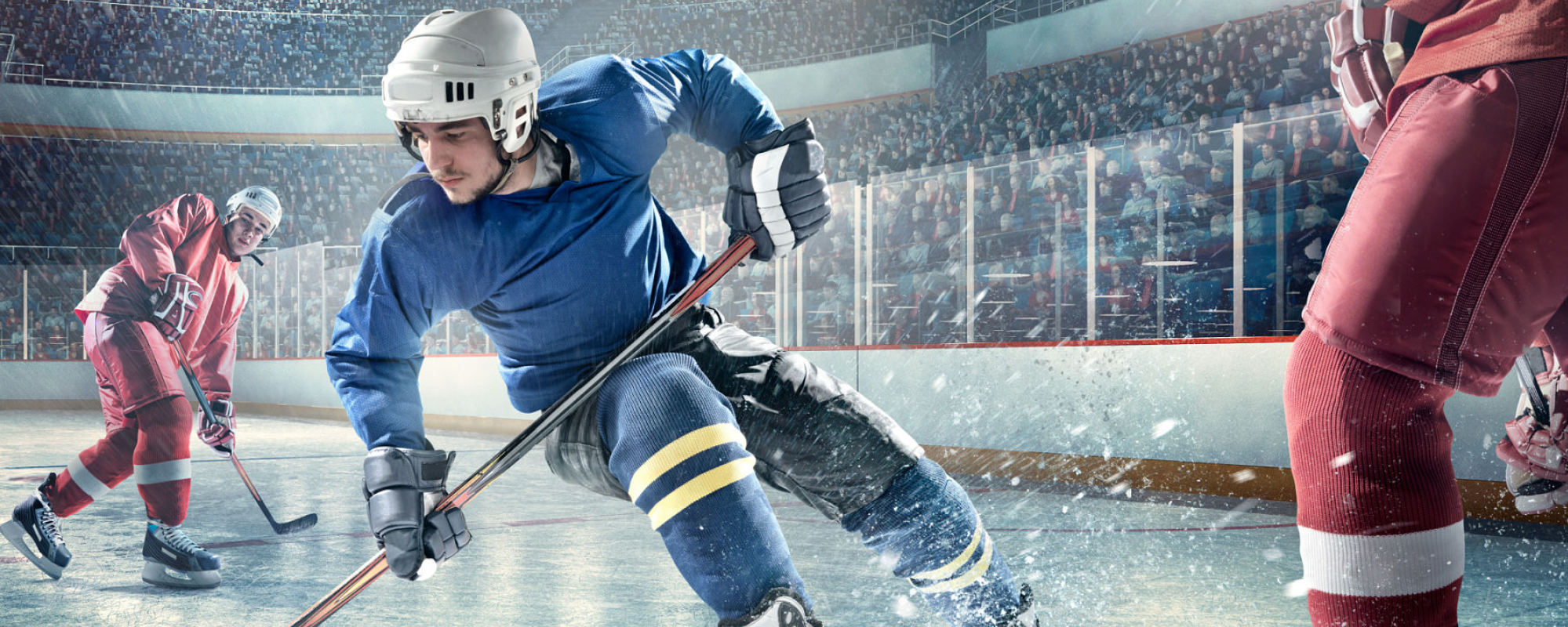 Hockey player skating on ice moving the puck