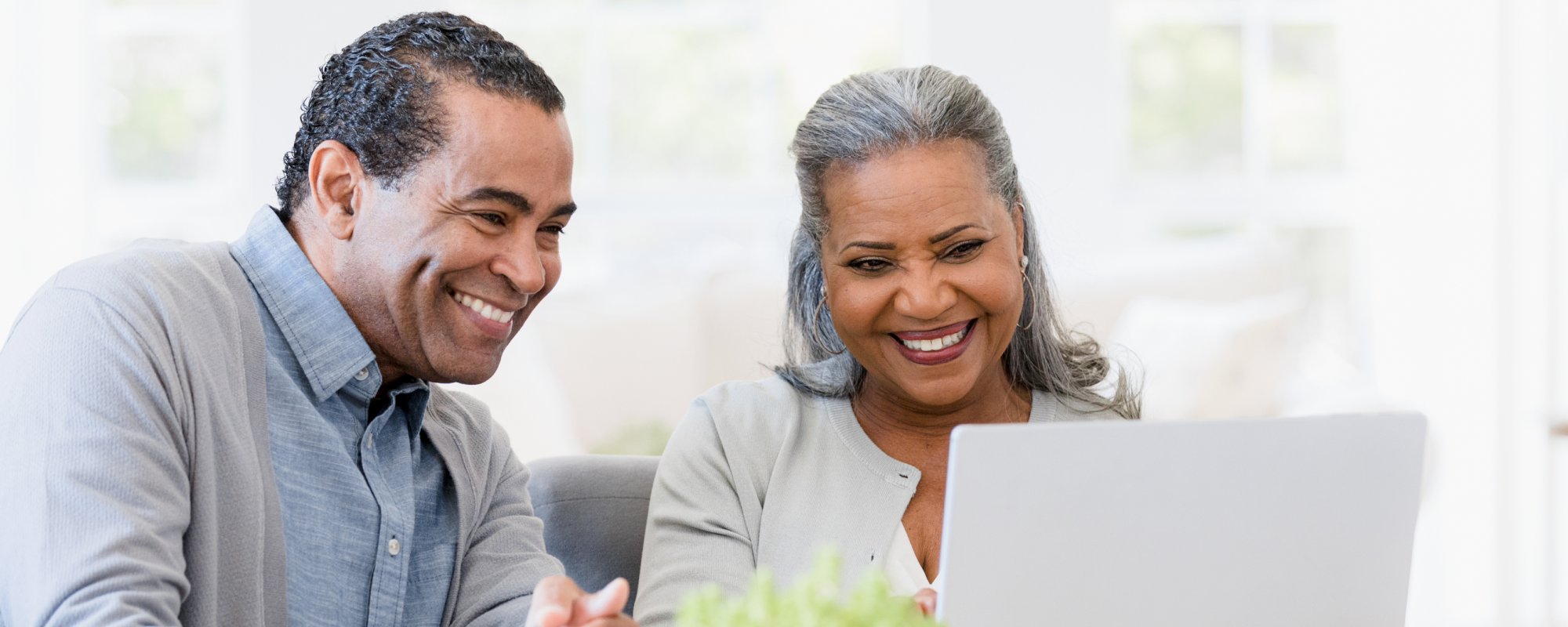 Man and woman smiling at laptop