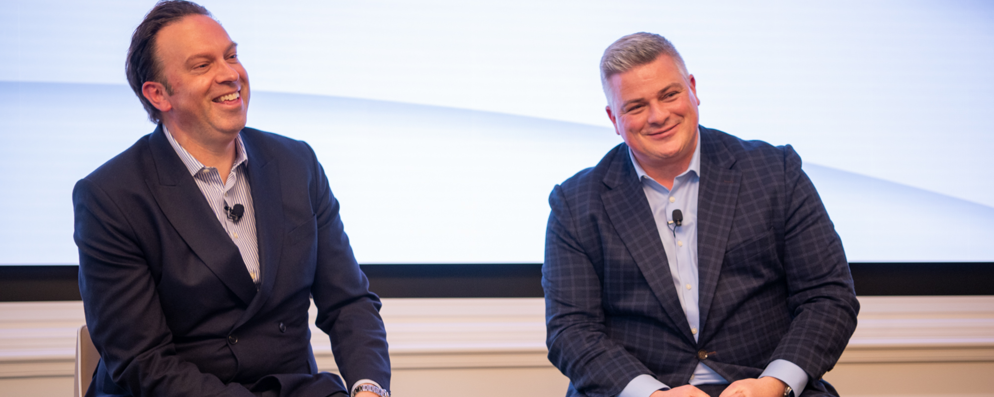 Elliott Friedman and Sheldon Keefe smiling on stage at a BMO Event