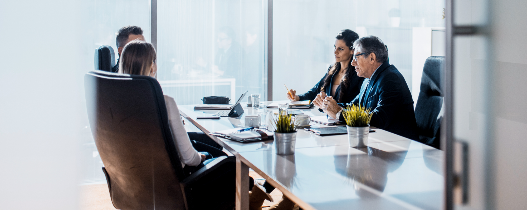 Wealth professionals in a meeting with a middle aged couple in the office
