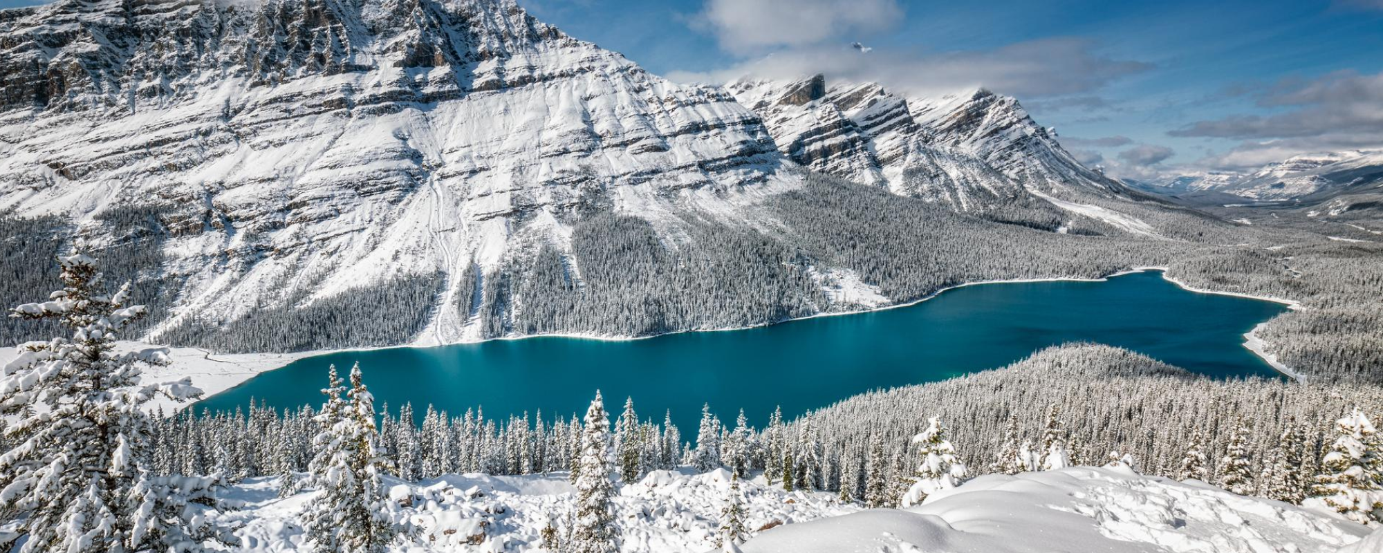 Landscape of snowy mountains and lake.