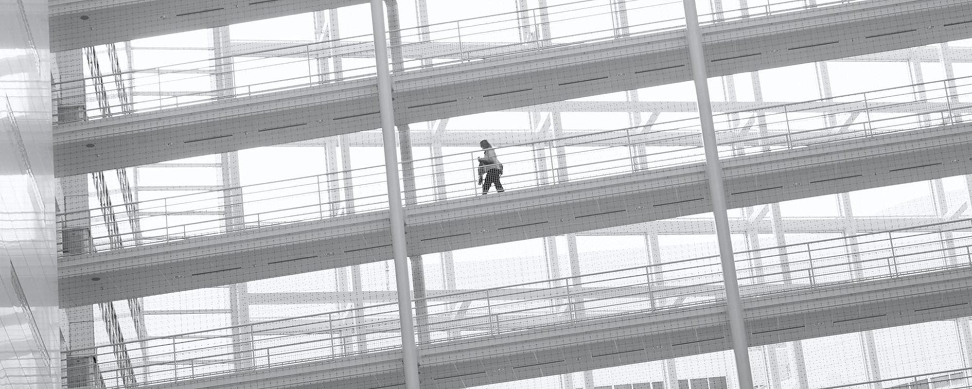 People walking on ramps outside office building.