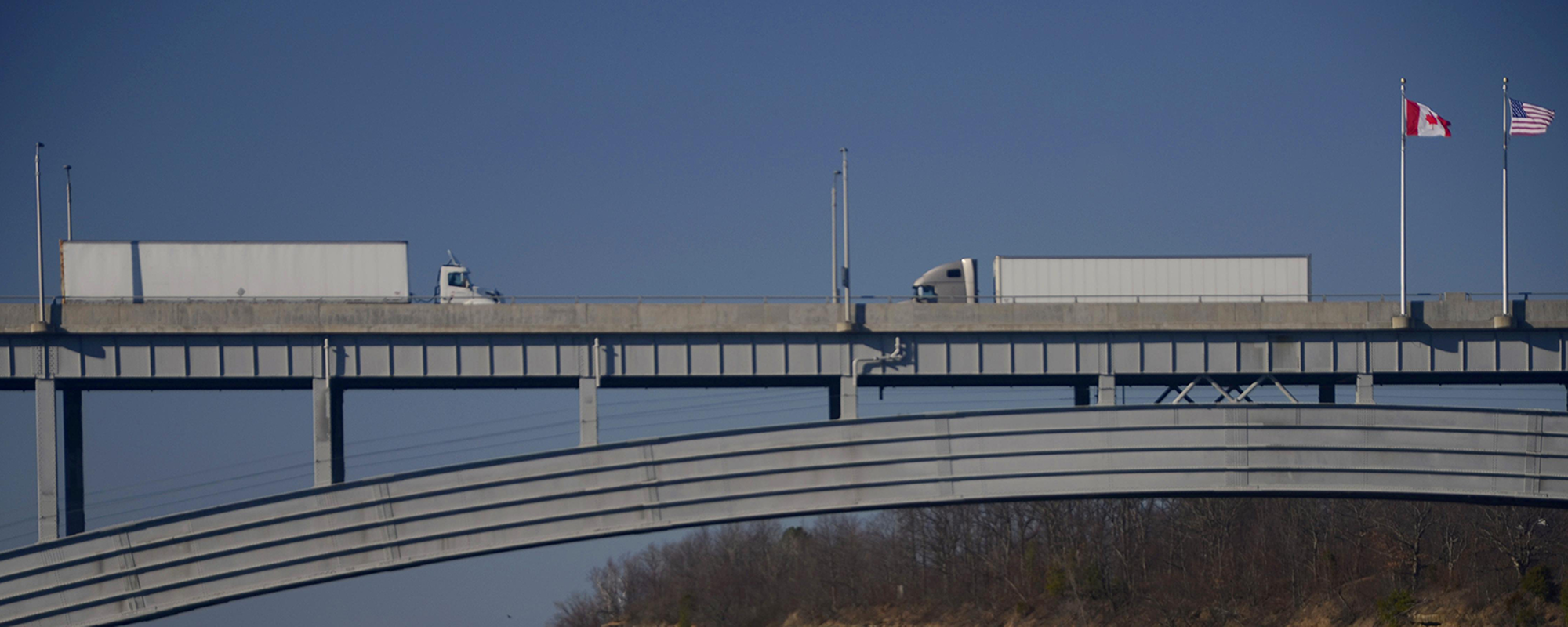 Trucks crossing a bridge.