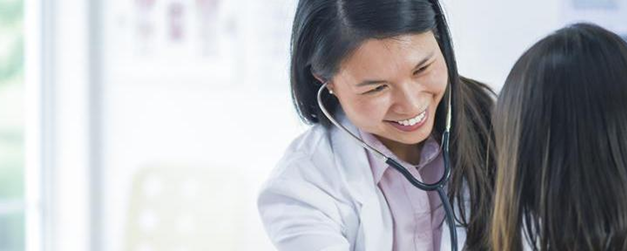 Doctor examining child with stethoscope.