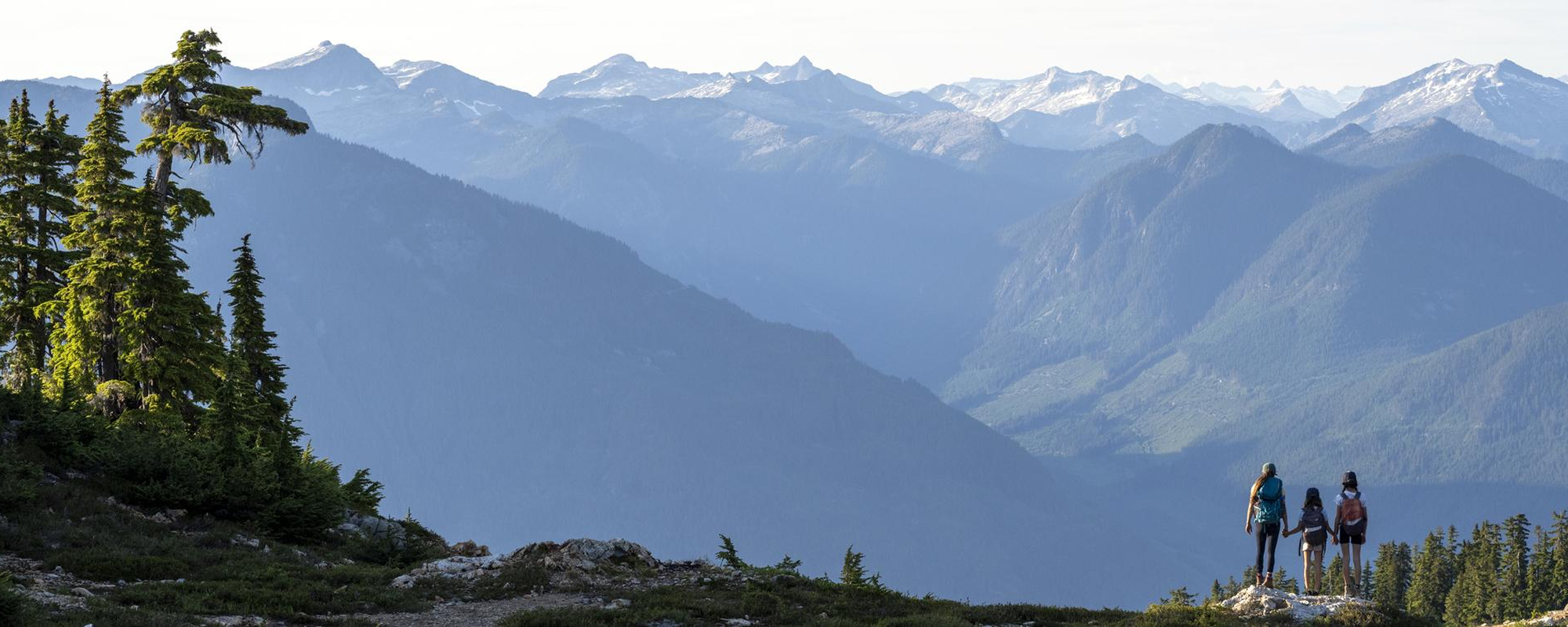 Mother and daughters hiking in the mountains. Nature and active lifestyle themes. Tetrahedron area of the Sunshine Coast..